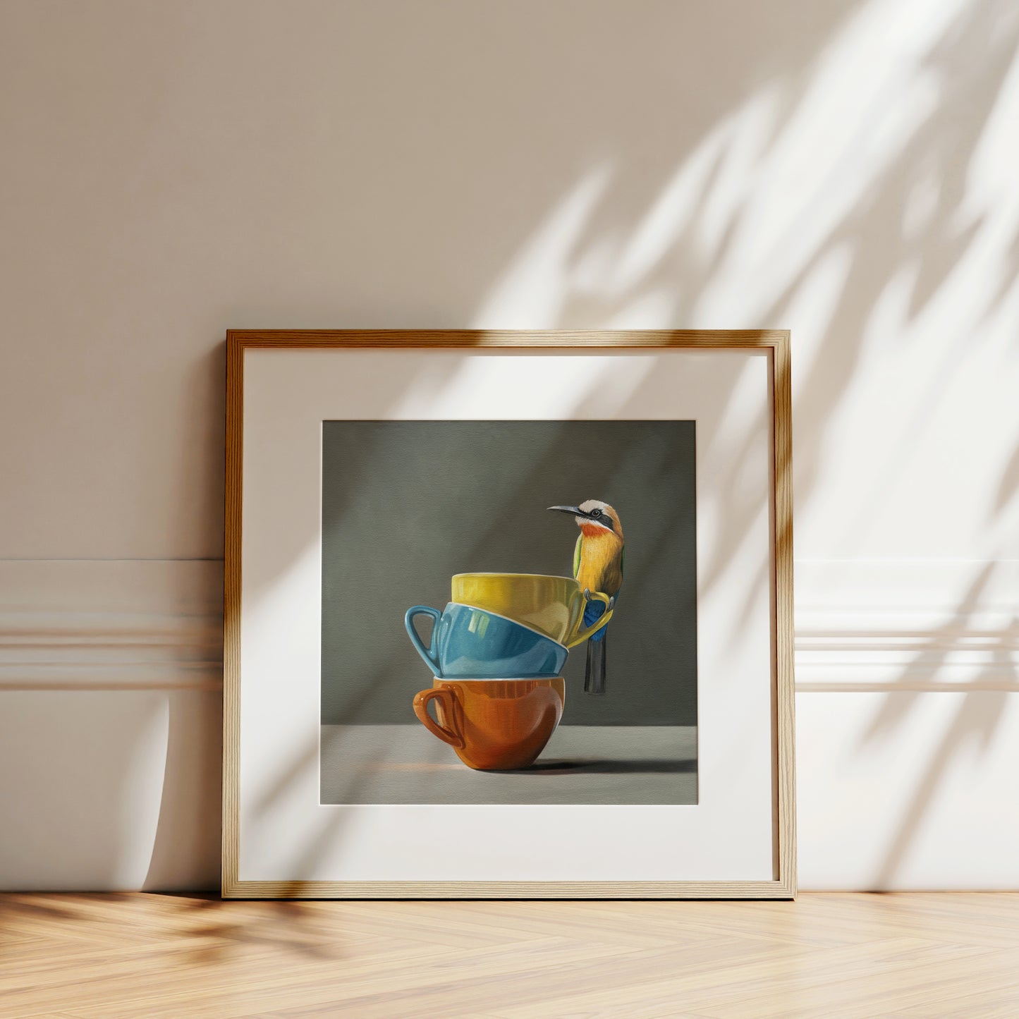 White Fronted Bee Eater & Rainbow Cups Fine Art Print by Lauren Pretorius: a White Fronted Bee Eater perched on top of a stack of colorful coffee cups.