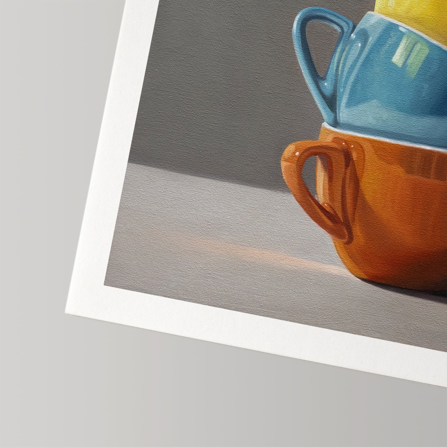Fine art print of stacked blue, orange, and yellow cups on museum-grade cotton rag paper with a white border.