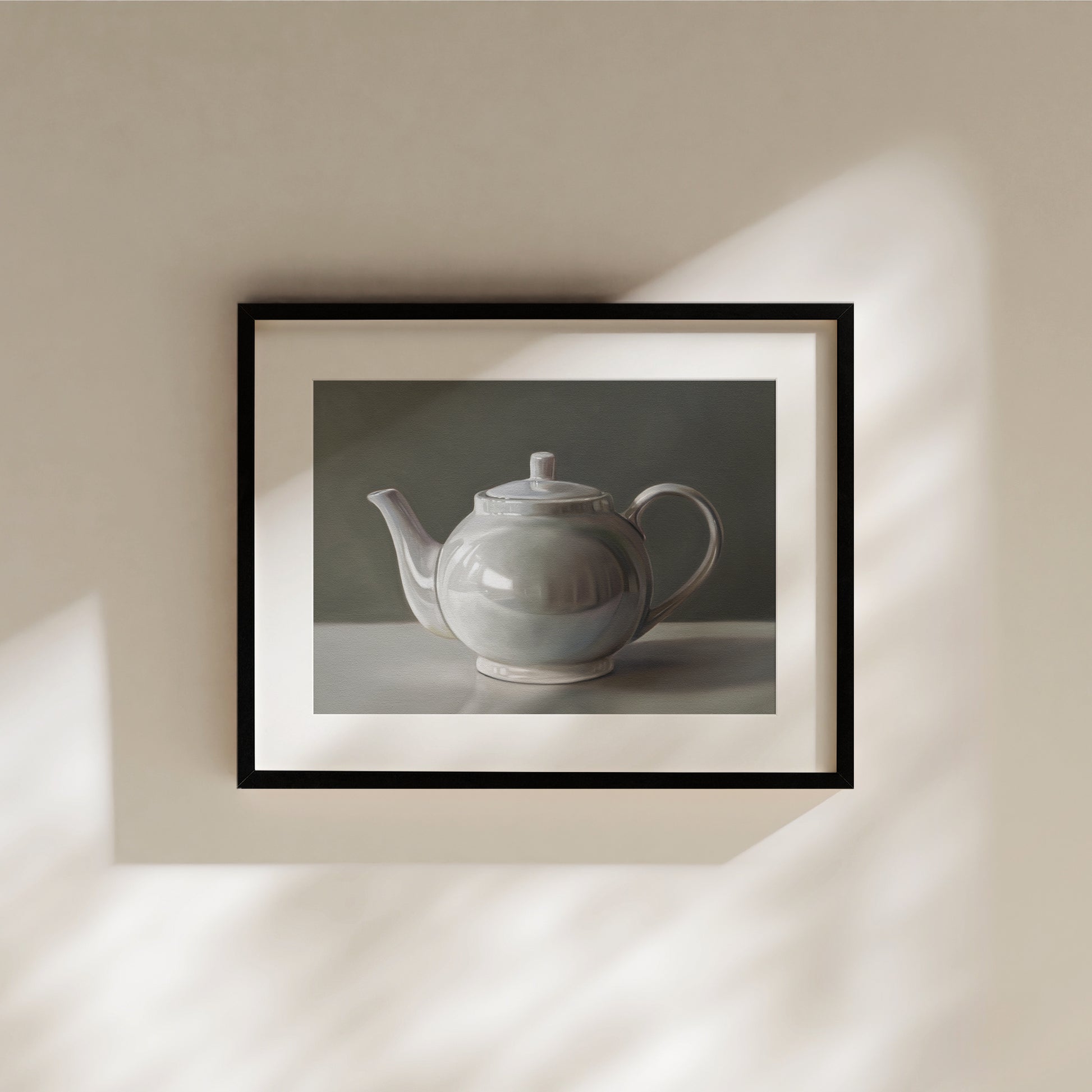 Framed fine art print of a white ceramic teapot with a lid, featuring a subtle reflection on its glossy surface.